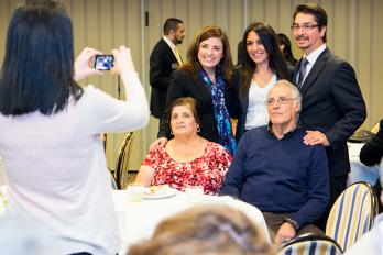 (Left Standing) Leticia Hernandez with her family and Nancy Astifo (center)